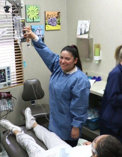 Dental team member setting up IV dental sedation drip