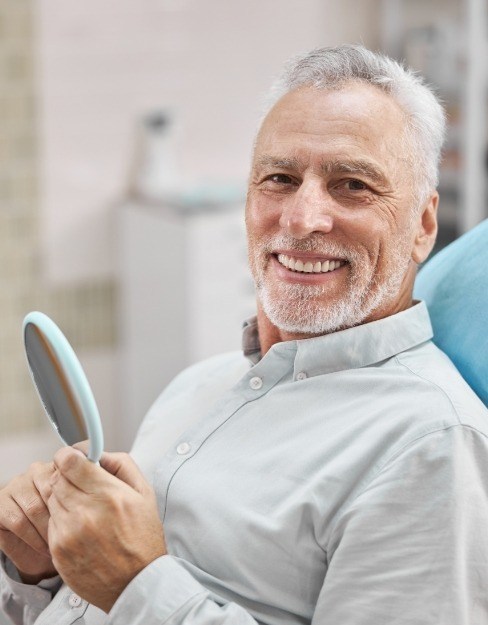 Smiling man with porcelain fused to metal dental crowns