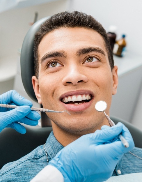 Man receiving preventive dentistry to avoid dental emergencies
