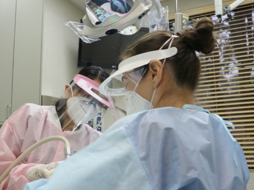 Two dental professionals in Houston treating a patient