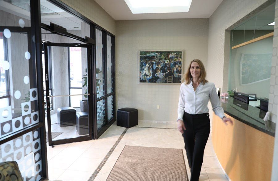 Woman standing by front desk in Houston dental office