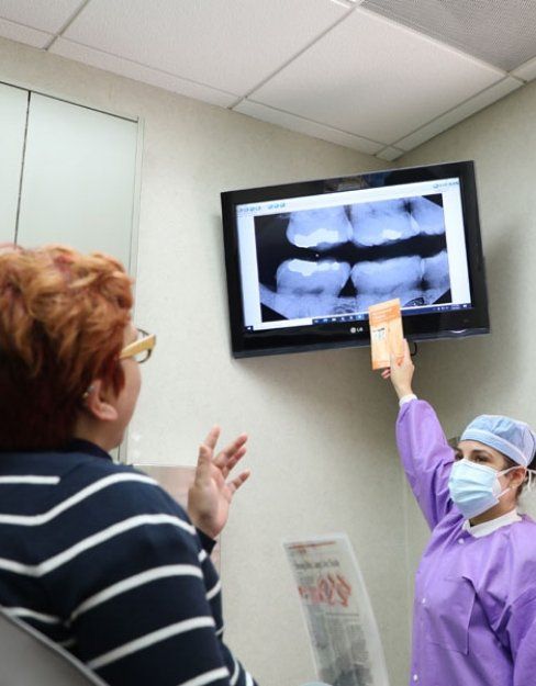 Dental team member showing patient their X ray in Houston