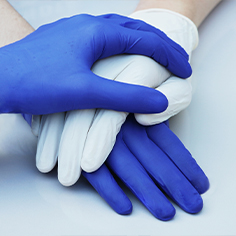 Hand blue and hand in white glove together