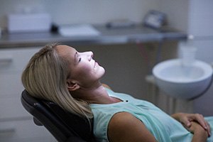 Woman relaxing after treatment with I V dental sedation