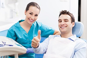 Man in dental office giving thumbs up