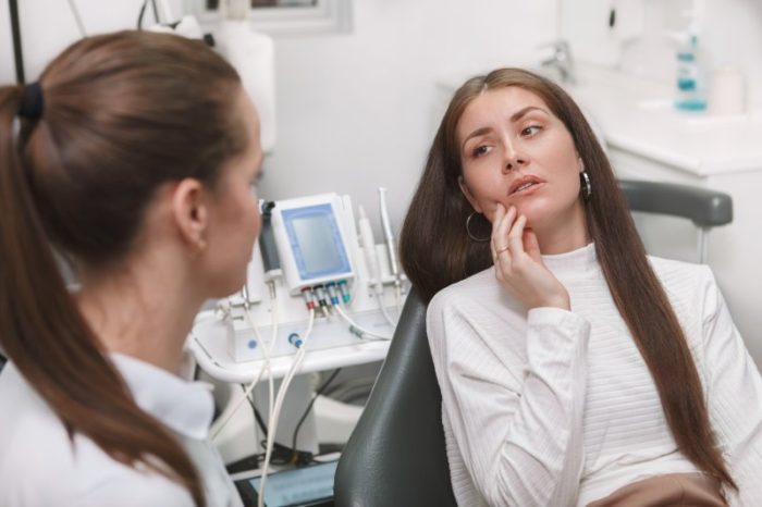 Weary patient talking to her dentist