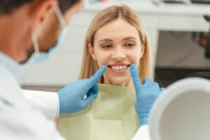 Woman getting an oral cancer screening during her routine bi-annual dental checkup
