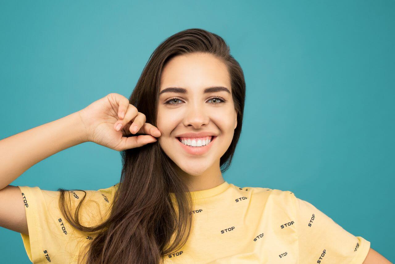 Girl smiling after teeth whitening session.